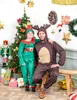 A father and child in Christmas costumes posing in front of a decorated Christmas tree. Anteprima dell’immagine prodotto
