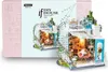 A miniature DIY house kit, specifically a loft-style house, is displayed in front of its packaging. Anteprima dell’immagine prodotto