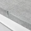 A close-up view of a gray fabric cushion with a zipper on a white surface. Produktbild-Vorschau