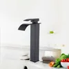 A black waterfall faucet is shown on a white sink counter. Produktbild-Vorschau
