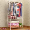 A white metal garment rack with clothes and folded bedding. Náhled obrázku produktu