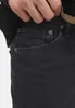 A close-up shot of a person's hand reaching into the pocket of dark wash jeans. Produktbild-Vorschau