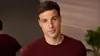 A man is looking at the camera with a slight smile, with a blurred reflection of himself in the background. Anteprima dell’immagine prodotto