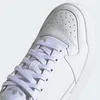 A close-up view of the toe and laces of a white Adidas sneaker. Náhľad obrázku produktu