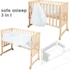 A collage of images showing a wooden crib with bedding and a sleeping bag, and a diagram of the crib. Produktbild-Vorschau