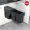 A pull-out trash bin system with multiple compartments installed inside a kitchen cabinet. Voir les images du produit
