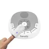 A finger is shown wearing a small device that is attached to a larger round electronic device with buttons and a speaker. Náhľad obrázku produktu