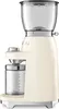 A cream-colored Smeg coffee grinder is shown against a white background. Náhled obrázku produktu