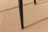 Close-up of the legs of a bistro set on a textured brown rug. Produktbild-Vorschau