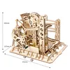 A wooden mechanical marble run model kit with marbles on a white background. Produktbild-Vorschau