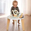 A baby is playing with a wooden activity table with a magnetic train and bead maze. Produktbild-Vorschau