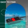 A handheld marine radio is floating in the water with a boat in the background. Náhled obrázku produktu