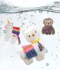 Three plush toys (a unicorn, a llama, and a sloth) are submerged in water with bubbles. Produktbild-Vorschau