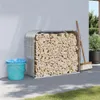 A firewood storage rack filled with wood, placed next to a wall, with a bucket and broom nearby. Náhľad obrázku produktu