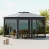 A gazebo with furniture inside, set up outdoors near the water with plants around. Produktbild-Vorschau