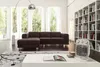 A living room with a sofa, bookshelf, and a heater. Voir les images du produit