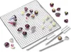 A collection of assorted chocolates and chocolate-making tools arranged on a wire cooling rack. Anteprima dell’immagine prodotto