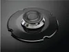 A close-up shot of a gas stove burner on a black glass cooktop. Voir les images du produit