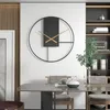A modern dining room with a stylish wall clock and dining table. Produktbild-Vorschau