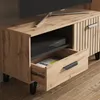A close-up view of a wooden TV stand with an open drawer and a media console inside the open compartment. Anteprima dell’immagine prodotto