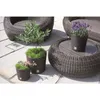 Outdoor patio furniture and planters with plants. Produktbild-Vorschau