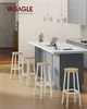 A modern kitchen island with bar stools, a laptop, and a vase of flowers. Produktbild-Vorschau