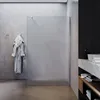 A modern bathroom with a frosted glass shower enclosure, a bathrobe hanging on a hook, and a marble countertop with a sink. Produktbild-Vorschau