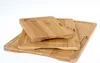 Three bamboo cutting boards stacked on top of each other against a white background. Produktbild-Vorschau