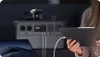 A person is using a tablet connected to a portable power station, with a laptop and camera in the background. Náhled obrázku produktu