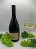 A bottle of white wine, a glass of white wine, and grapes on a white background. Produktbild-Vorschau