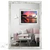 A living room scene with a pink sofa, a mirror reflecting a sunset picture, and a floor lamp. Produktbild-Vorschau