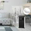 A modern living room scene featuring a portable air conditioner. Voir les images du produit