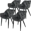 A set of four grey velvet dining chairs with black legs, arranged in a group against a white background. Náhled obrázku produktu