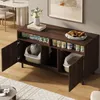 A dark wood sideboard with open compartments, one containing a cat litter box and another a sleeping cat on a cushion. The top shelf displays cat food cans and boxes, with a vase of flowers and books. Anteprima dell’immagine prodotto