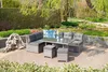 A garden furniture set with a table and seating, placed on a patio surrounded by greenery. Produktbild-Vorschau
