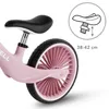Close-up of a pink balance bike's rear wheel and seat, with a diagram showing seat height adjustment. Náhľad obrázku produktu