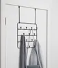 An over-the-door coat rack with multiple hooks hangs on a white door. Produktbild-Vorschau