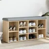 A shoe bench with multiple compartments, some filled with shoes, against a white wall. Náhled obrázku produktu