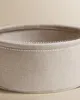 Close-up shot of the top edge of a round, fabric basket. Produktbild-Vorschau