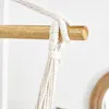 A close-up of a rope knot securing a hammock chair to a wooden bar. Produktbild-Vorschau