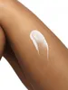 A close-up shot of a dollop of white lotion on a person's leg. Náhľad obrázku produktu