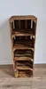 A tall, narrow shelving unit made of wooden crates, standing against a white wall with a wooden floor in front. Produktbild-Vorschau