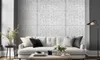 A living room scene with a white sofa in front of a white brick-patterned wall. Produktbild-Vorschau