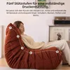 A woman is relaxing on a large, segmented beanbag chair, with numbered points indicating support levels. Náhľad obrázku produktu