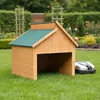 A wooden dog house or mower garage sits on a green lawn with a robotic lawnmower nearby. Voir les images du produit