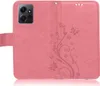 A pink flip case for a smartphone, with a floral and butterfly embossed design. Produktbild-Vorschau