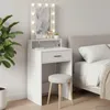 A white vanity table with a lighted mirror and a stool, placed next to a bed. Voir les images du produit