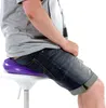 A person sitting on a purple balance cushion on a white stool. Podgląd zdjęcia produktu