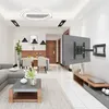 A modern living room with a TV mounted on the wall, a sofa, coffee table, and dining area. Produktbild-Vorschau