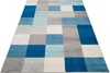 A rectangular rug with a geometric pattern of blue, gray, and white squares and rectangles, laid out on a white background. Náhled obrázku produktu